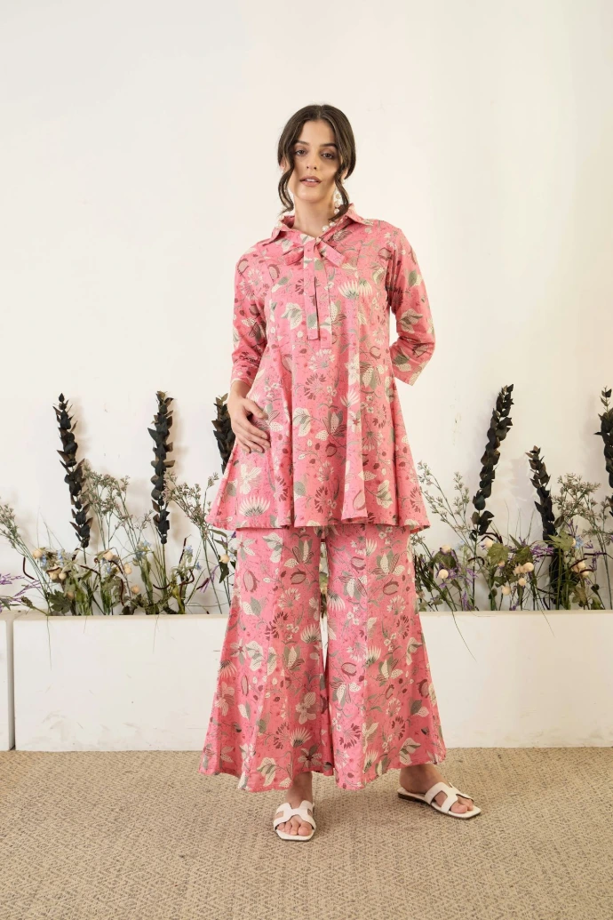 Woman in pink floral matching set with bow detail